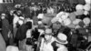 FILE - People of Japanese ancestry board buses in Los Angeles, for Owens Valley, 235 miles north, where the government's first alien reception center is under construction, March 21, 1942. 