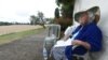 FILE - Genevieve Callerot, 102, sits in the garden of her farm, on Aug. 25, 2018, in Saint-Aulaye, southwestern France. 