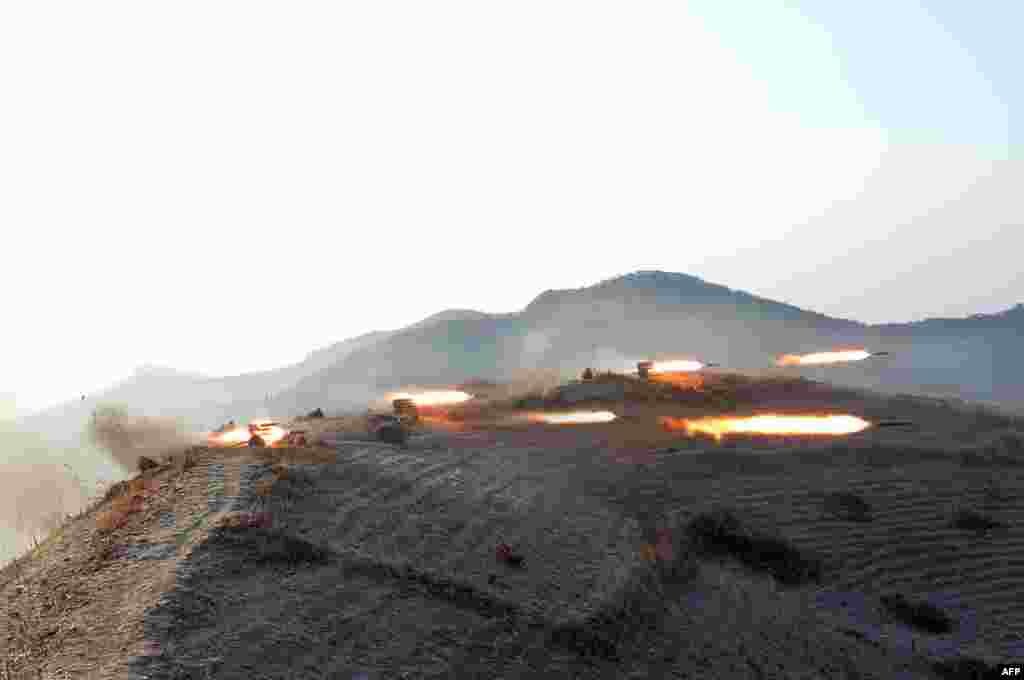 This undated photo released by North Korea&#39;s official Korean Central News Agency (KCNA) shows rocket artillery being fired during maneuvers for attack and defense between large combined units of the Korean People&#39;s Army (KPA) staged in three directions at the same time at an undisclosed location.&nbsp;