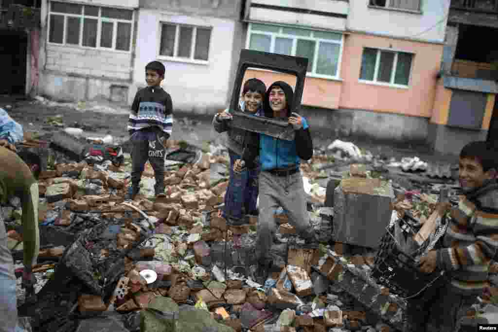 Anak-anak Bulgaria Roma berpose ketika difoto saat&nbsp; mereka menyelamatkan barang-barang yang masih bisa digunakan dari bangunan yang dihancurkan di pinggiran Roma di kota Plovdiv. Pejabat berwenang di wilayah itu mulai menghancurkan sekitar 50 bangunan ilegal yang terdiri dari rumah-rumah dan toko-toko di wilyah itu. &nbsp;