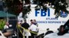 Law enforcement officials gather outside the Pulse nightclub, the scene of Sunday's mass shooting, June 15, 2016, in Orlando, Fla. 