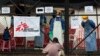 A man showing symptoms of Ebola waits to be granted entrance at a treatment center in Monrovia, Liberia, Monday Sept. 29, 2014. The man was admitted shortly thereafter. Six months into the world’s worst-ever Ebola outbreak, and the first to happen in an u