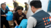 유엔인구기금, UNFPA 직원이 북한 주민들에게 의약품 등 지원물품을 나눠주고 있다. (자료사진)