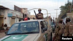 Security forces patrol at a suicide bomb blast site in Bannu