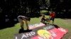 FILE - Protesters arrange signs in a social distanced crowd during an Aboriginal-lead Invasion Day rally on Australia Day in Sydney, Jan. 26, 2021. 