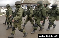 UKRAINE – Russian soldiers march outside an Ukrainian military base in Perevalne, Crimea, March 20, 2014.