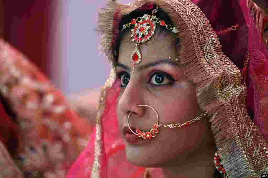 An Indian bride waits during a mass-marriage ceremony at a local temple in the old quarter of New Delhi.