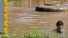 A man wades through flooded area in Ayutthaya province, Thailand, Oct. 2, 2013.