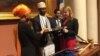 Ilhan Omar takes the Oath of Office on a special Koran in a ceremony at the Minnesota State Capitol Building, Jan. 3, 2017. (K. Farabaugh/VOA)