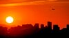 FILE - A jet takes flight from Sky Harbor International Airport as the sun sets over Phoenix, July 12, 2023.