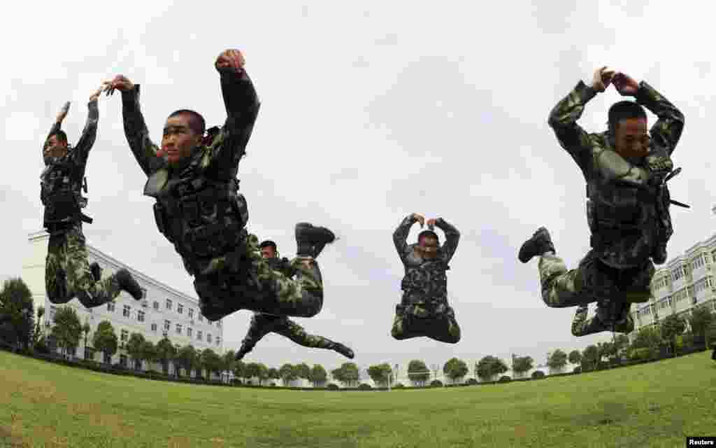 Polisi paramiliter melakukan lompatan dalam sebuah latihan musim panas di Bozhou, Provinsi Anhui, China. 