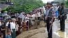 A Myanmar policeman and soldier provide security