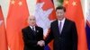 Cambodian King Norodom Sihamoni, left, and Chinese President Xi Jinping shake hands at the Great Hall of the People in Beijing, Tuesday, May 14, 2019. (Jason Lee/Pool Photo via AP)
