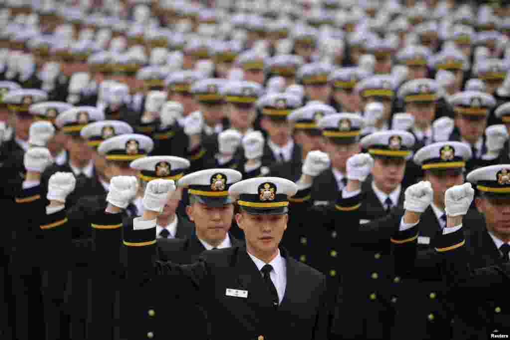 New military officers salute during a military commissioning ceremony at Gyeryongdae, South Korea&#39;s main military compound in Gyeryong. A total of 6,003 graduates from the country&#39;s six major military academies were commissioned.