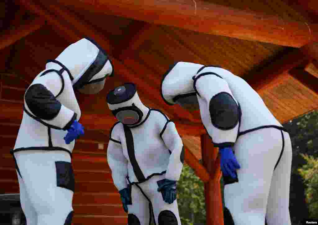 Jake Bodart (L), Austin Johnson (C) and Jessica Rendon (L) of the Oregon Department of Agriculture wear hornet extraction suits during an Asian giant hornet field training day at Birch Bay State Park near Blaine, Washington, Aug. 18, 2021.&nbsp;