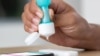 FILE - A person uses Ellume's first over-the-counter coronavirus disease (COVID-19) antigen test, which can be used at home, in this undated image. (Ellume/Handout via Reuters)