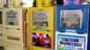 FILE - Copies of The Fort Lauderdale Sun-Sentinel, The Miami Herald and El Nuevo Herald sit in newsstands in North Miami-Dade, Florida, Nov. 8, 2000. 