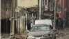 A body is seen at the site of a bomb explosion at a road in Kaduna, Nigeria, April 8, 2012.
