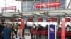 FILE - Travelers wait in line at a Virgin Australia Airlines counter at Kingsford Smith International Airport, following the coronavirus outbreak, in Sydney, Australia, March 18, 2020.