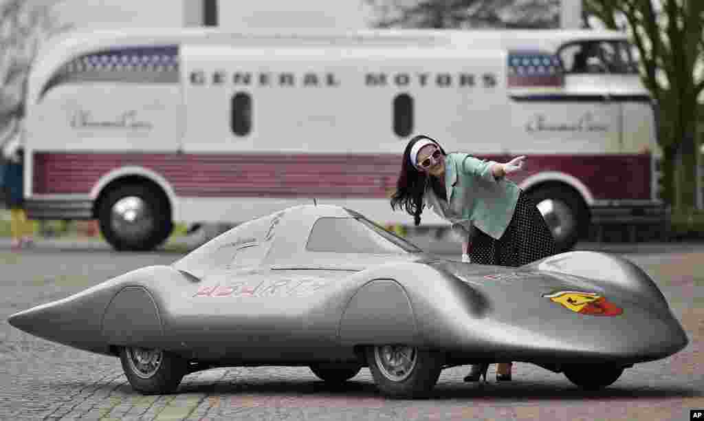 Natasha poses for photographers with a vintage Fiat-Abarth 1000 Pininfarina to promote the vintage car show 'Techno Classica' in Essen, Germany.