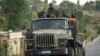 FILE - Ethiopian government soldiers ride in the back of a truck in the Tigray region of northern Ethiopia, May 11, 2021. 