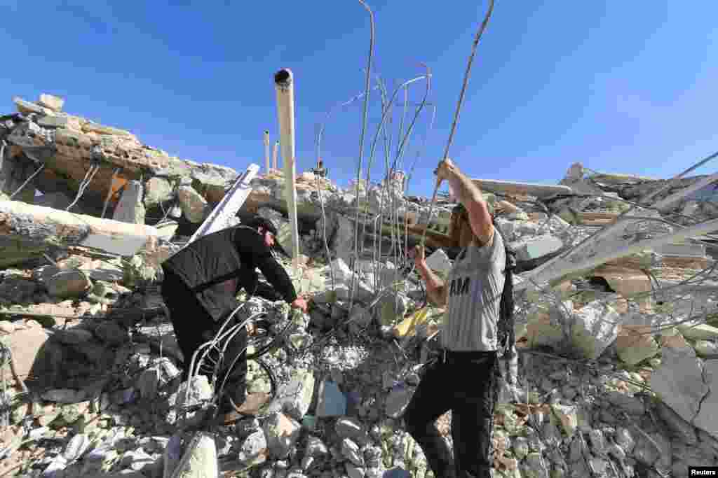 People look for survivors in the ruins of a destroyed hospital supported by Medecins Sans Frontieres (MSF) that was hit by missiles in Marat Numan, Idlib province, Syria.