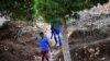 FILE - A migrant, who arrived from Eritrea through Libya, walks from a migrants reception and identification center, on the Italian island of Lampedusa, Sept. 26, 2018.