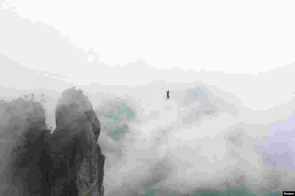 A competitor walks on tightrope during a performance in Taizhou, Zhejiang Province, China, May 7, 2016.