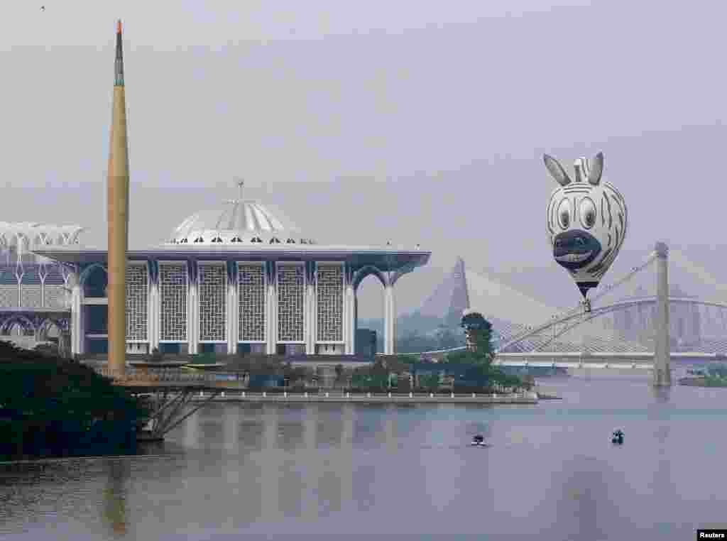 A balloon flies near the Tuanku Mizan Zainal Abidin mosque during the Hot Air Balloon festival in Putrajaya, Malaysia.