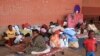Des familles de migrants et de réfugiés occupent dans le camp de fortune de la Place de la République à Mamoudzou, capitale de Mayotte, le 16 juin 2016