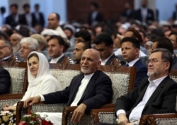 FILE - Current Afghan president and presidential candidate Ashraf Ghani, center, attends the first day of campaigning in Kabul, Afghanistan, July 28, 2019.