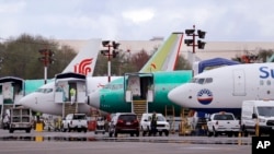 FILE - Boeing 737 Max aircraft are parked at the airport adjacent to a Boeing Co. production facility in Renton, Wash., April 8, 2019. 
