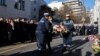 French President Macron and other officials take part in a ceremony commemorating the anniversary of an attack on Charlie Hebdo, outside the weekly's former offices in Paris, Jan. 7, 2025.