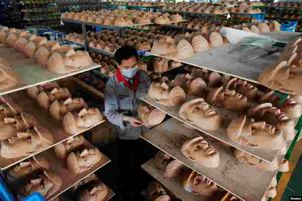 A worker checks a mask of U.S. Republican presidential candidate Donald Trump, at Jinhua Partytime Latex Art and Crafts factory in Jinhua, Zhejiang Province, China, May 25, 2016.