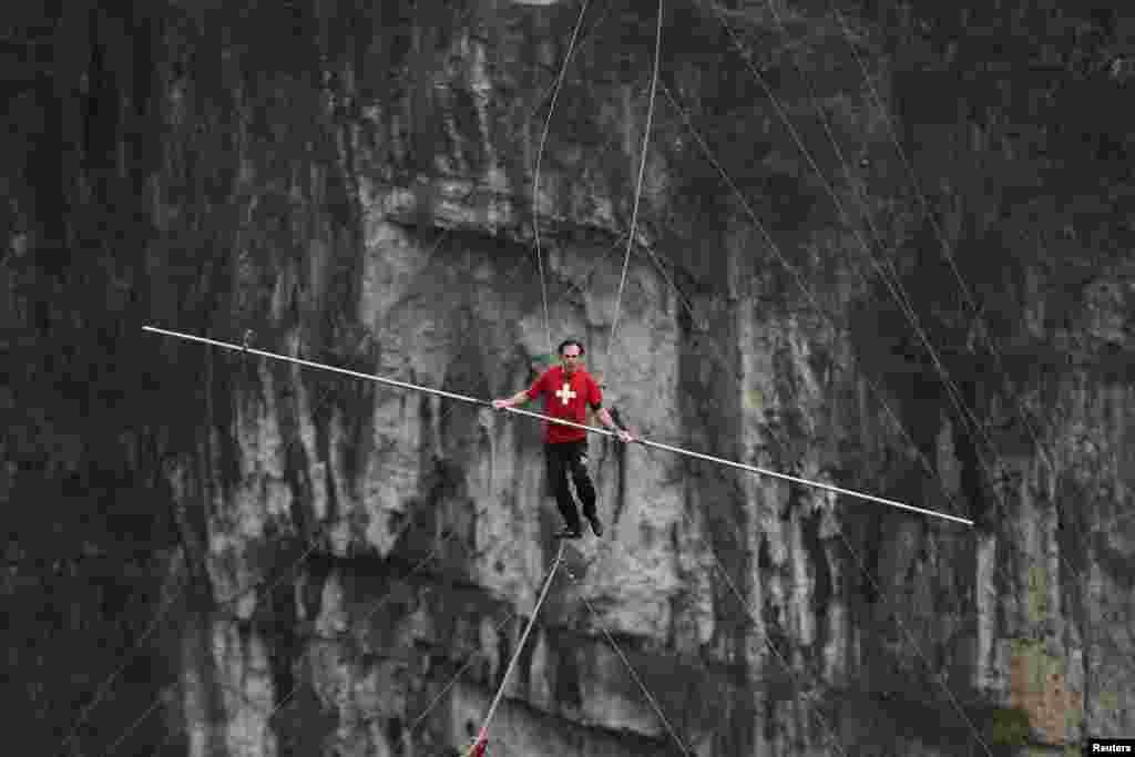Freddy Nock of Switzerland walks on a tightrope during a competition in Wulong county, Chongqing, China.
