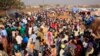Displaced people walk around Tomping camp in Juba, where some 21,000 people who fled their homes are sheltered by the United Nations, Jan. 7, 2014. 