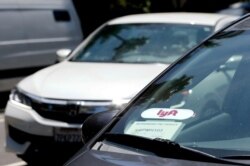 In this July 9, 2019, photo, a Lyft ride-share car waits at a stoplight in Sacramento, California.