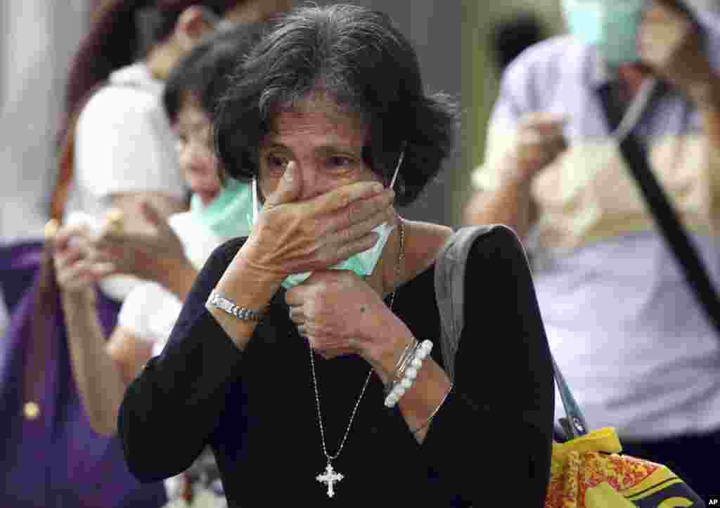 A relative of a victim of AirAsia Flight 8501 cries as she waits for the handover of the body to the family at a police hospital in Surabaya, East Java, Indonesia, Jan. 5, 2015.