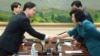 In this photo released by the South Korean Unification Ministry, South Korea's Unification Policy Officer Chun Hae-sung, left, shakes hands with the head of North Korea's delegation Kim Song Hye, right, June 10, 2013.