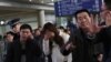 失踪马航班机MH370上的乘客亲属在北京首都机场焦急和哀伤地等待亲人消息。（2014年3月8日）