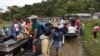 FILE - People transport the coffins of two indigenous people killed in Tacueyo, southwest Colombia, Oct. 31, 2019.
