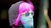 A person wears a scarf as a protective face mask in Melbourne, the first city in Australia to enforce mask-wearing to curb a resurgence of COVID-19.