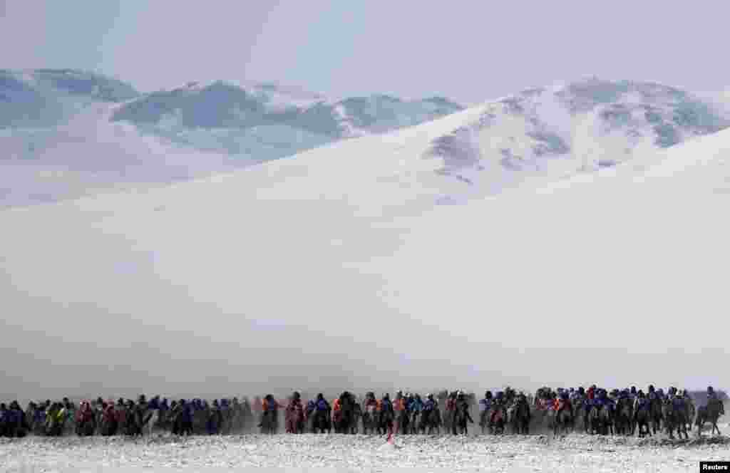 Riders attend a spring horse racing event in Tsagaan Khutul, outside of Ulaanbaatar, Mongolia, February 28, 2016. 