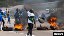 Supporters of former South African President Jacob Zuma block the freeway with burning tyres during a protest in Peacevale, South Africa, July 9, 2021. REUTERS/Rogan Ward