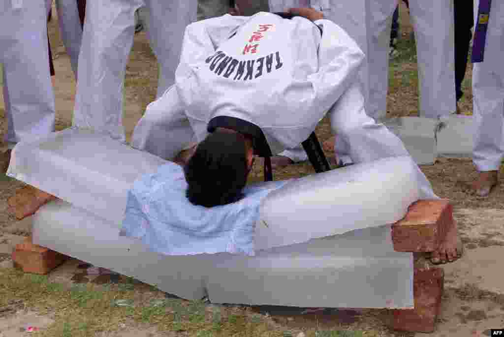 An Indian student demonstrates martial arts skills during a sports event at a college in Amritsar.