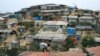 A Rohingya refugee repairs the roof of his shelter at the Balukhali refugee camp in Cox's Bazar, Bangladesh, March 5, 2019.