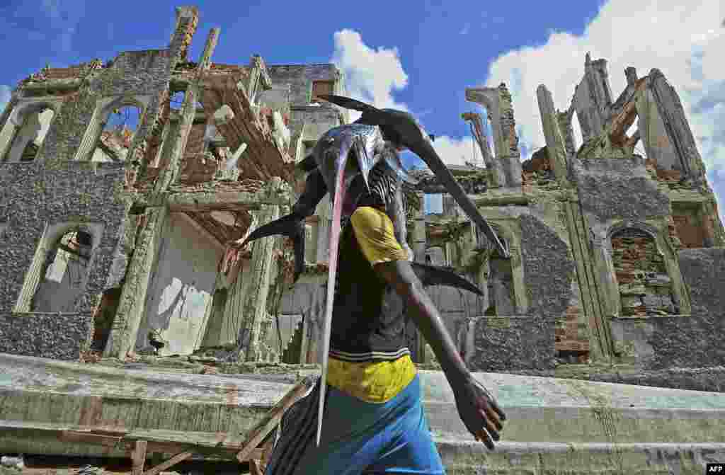 A fisherman carries a sailfish on his head to the fish market in Hamarweyne near the port of Mogadishu, Somalia.