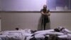 A Syrian amputee looks at bodies of civilians reportedly killed in regime airstrikes on Muhambal, in northern Idlib province, July 6, 2019. A Syrian regime bombardment killed 14 civilians, including seven children, a war monitor said.
