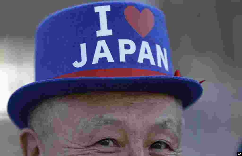 Seorang penggemar dari Jepang mengantre untuk masuk Stadion Maracana menjelang upacara pembukaan Olimpiade Musim Panas 2016 di Rio de Janeiro, Brazil (5/8). (AP/Natacha Pisarenko)
