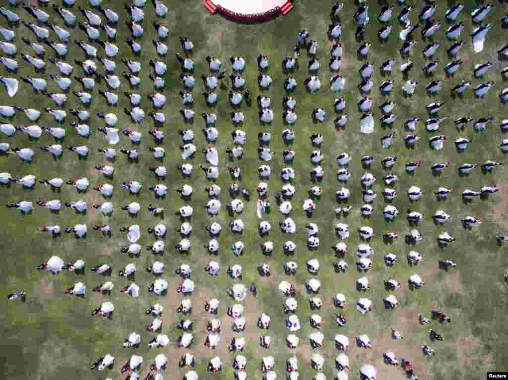 Newlywed couples attend a mass wedding ceremony in Hangzhou, Zhejiang province, China.